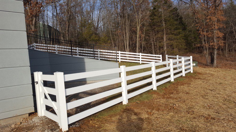 White vinyl split-rail fence paired with black aluminum fencing