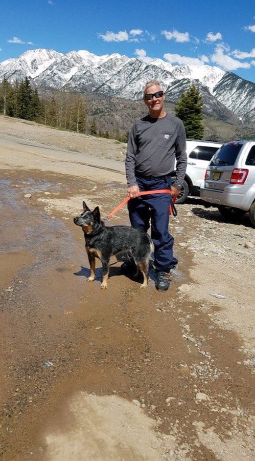 J.R. Robinson, founder of J.R.'s Fine Fences, hiking with his dog Picket